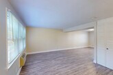 Located at 19 Beacon Park Dr in East Providence, Rhode Island, this two-story home offers three bedrooms, two bathrooms, and a thoughtfully organized layout spread evenly across two floors. The main level features an open living and dining area highlighted by light wood-style flooring, warm neutral walls, and natural light streaming through large windows with blinds. The kitchen is well-appointed with rich wood cabinetry, granite countertops, stainless steel appliances including a gas range, microwave, and dishwasher, plus recessed lighting and crown molding details. A dedicated entrance and utility room add practical convenience on this level. Upstairs, the three bedrooms offer plush carpeting and neutral tones. The spacious primary bedroom benefits from dual windows and a ceiling fan, creating a bright and comfortable retreat. Additional bedrooms are well-sized with clean finishes and ample natural light. The two bathrooms are finished in crisp white, with one featuring a tub/shower combo, marble-style tile flooring, and white vanity cabinetry. Five closets distributed throughout the home provide generous storage. The overall ambiance is clean, functional, and move-in ready.