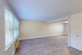 Located at 19 Beacon Park Dr in East Providence, Rhode Island, this two-story home offers three bedrooms, two bathrooms, and a thoughtfully organized layout spread evenly across two floors. The main level features an open living and dining area highlighted by light wood-style flooring, warm neutral walls, and natural light streaming through large windows with blinds. The kitchen is well-appointed with rich wood cabinetry, granite countertops, stainless steel appliances including a gas range, microwave, and dishwasher, plus recessed lighting and crown molding details. A dedicated entrance and utility room add practical convenience on this level. Upstairs, the three bedrooms offer plush carpeting and neutral tones. The spacious primary bedroom benefits from dual windows and a ceiling fan, creating a bright and comfortable retreat. Additional bedrooms are well-sized with clean finishes and ample natural light. The two bathrooms are finished in crisp white, with one featuring a tub/shower combo, marble-style tile flooring, and white vanity cabinetry. Five closets distributed throughout the home provide generous storage. The overall ambiance is clean, functional, and move-in ready.