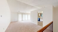 This single-floor home in Midland, Michigan offers a well-organized layout with four bedrooms, two full bathrooms, and a dedicated laundry room. The expansive living area is anchored by soft carpeting and a wall of vertical blinds that filter abundant natural light, creating a bright and airy atmosphere. A textured ceiling adds a classic touch throughout the main living spaces. The kitchen is efficiently designed with white cabinetry, a dark dishwasher, and tile flooring, opening directly to the living area through an arched passageway for a connected, functional flow. The primary bedroom is generously sized and features vaulted ceilings, a large double-door closet with warm wood-toned doors, and direct access to a private en-suite bathroom complete with a standing shower, single-sink vanity, and tile flooring. The second bathroom includes a tub-shower combination with tiled surround, a single-sink vanity topped with a wide mirror and lighted fixture, and matching tile flooring. The additional bedrooms are carpeted and well-proportioned, offering comfortable living space. The dedicated laundry room provides tile flooring and added utility. Throughout the home, warm wood-toned interior doors and neutral finishes contribute to a clean, cohesive aesthetic.