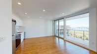 Located at 915 W Grape St in San Diego's Bankers Hill neighborhood, this contemporary single-floor residence offers a clean, modern design with a bright and open layout. Warm hardwood-style flooring runs consistently throughout the entire space, creating a cohesive and inviting atmosphere.

The open-concept living and kitchen area is a standout feature, bathed in natural light through expansive floor-to-ceiling sliding glass doors that lead directly to a private balcony. The balcony provides open views of the surrounding San Diego cityscape, making it an ideal spot for outdoor relaxation. Recessed lighting throughout the ceiling complements the abundant natural light.

The kitchen is efficiently integrated into the main living space and is outfitted with white cabinetry, a stainless steel refrigerator, and a dishwasher, offering a clean and functional aesthetic.

The bedroom is a well-proportioned, private room featuring large windows that invite natural light and views of the surrounding building community. It includes access to a closet, providing practical storage solutions.

The bathroom maintains the home's clean, modern palette with white subway tile lining the tub and shower surround, a white vanity, and matching hardwood-style flooring that ties the space together seamlessly.

Overall, this residence offers a bright, minimalist aesthetic well-suited to contemporary urban living in San Diego.