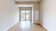 Located at 208 Woolwich St S in Breslau, Ontario, this well-appointed 2-bedroom, 2-bathroom unit offers a thoughtfully designed single-floor layout. Light-toned hardwood flooring runs throughout, lending a warm, cohesive feel to the space. The open-concept kitchen, dining, and living area forms the heart of the unit, anchored by a kitchen featuring rich dark-brown cabinetry, granite countertops, a subway tile backsplash, a double stainless steel sink, and a full suite of stainless steel appliances including a refrigerator, stove, microwave, and dishwasher. A breakfast bar provides additional seating and casual dining space. The living area extends toward a sliding glass door that opens onto a private balcony, offering scenic views of mature evergreen trees and the surrounding neighbourhood. Both bedrooms are generously sized with large windows that invite natural light; the primary bedroom includes ample closet space. Two full bathrooms and a dedicated in-unit laundry area add to everyday convenience. A welcoming entrance and hallway connect the spaces efficiently. With five closets throughout, storage is plentiful. The unit's neutral palette and modern finishes create a clean, contemporary ambiance throughout.