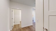 Located at 95 Plum Nelly Circle in Nashville, TN, this well-appointed 2-bedroom, 2-bathroom residence offers a thoughtfully designed single-floor layout. The kitchen serves as a central highlight, featuring a large island with pendant lighting, quartz countertops, gray shaker-style cabinetry with matte black hardware, a subway tile backsplash, and a full suite of stainless steel appliances including a refrigerator, range, microwave, and dishwasher. Wood-look flooring flows throughout the main living and kitchen areas, lending warmth and continuity.

Both bedrooms are carpeted and filled with natural light through large windows with wooded views, and each is equipped with a ceiling fan. The primary bedroom connects to a dedicated closet with built-in shelving. The primary bathroom features wood-look flooring, a glass-enclosed shower, a gray vanity with quartz countertop, and direct access to a walk-in closet. The second bathroom mirrors this refined aesthetic with matching finishes.

A dedicated laundry room houses a full-size GE washer and dryer. Two hallways provide seamless connectivity throughout the layout. Clean white walls, consistent finishes, and practical storage solutions create a cohesive and functional living environment.
