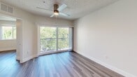 Located at 20950 NW 14th Pl in Miami Gardens, Florida, this one-bedroom, one-bathroom unit offers a thoughtfully designed layout with modern finishes throughout. Wood-look luxury vinyl flooring runs seamlessly across the entire space, complementing the clean, neutral color palette of white walls and bright recessed lighting.

The open-concept kitchen and living area serves as the heart of the unit. The kitchen features a peninsula with striking marble-look countertops, white cabinetry, a black gas range, a stainless steel refrigerator, and an integrated sink — all arranged for both functionality and style. The living area flows naturally from the kitchen, bathed in natural light from a large sliding glass door that opens to a private balcony overlooking lush, mature greenery.

The bedroom is a comfortable and well-proportioned retreat, featuring a ceiling fan with light, a window framing verdant outdoor views, and a built-in closet with classic panel doors. The textured ceiling adds a subtle architectural detail to the room.

The bathroom maintains the unit's clean aesthetic with a marble-look vanity countertop, white cabinetry, and a well-lit mirror. Every room reflects a consistent commitment to modern, low-maintenance design, making this unit a practical and attractive residence in Miami Gardens.