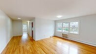 This well-designed 680 square foot apartment in Lakewood, NJ offers a comfortable living space with a thoughtful layout. The single-story unit boasts gleaming hardwood floors throughout, creating a warm and cohesive aesthetic. The spacious primary bedroom, measuring 170 square feet, features built-in closets and a large window that floods the room with natural light. The kitchen is a highlight, showcasing honey-toned wooden cabinetry, ample counter space, and a double sink, perfect for meal preparation. The living area is open and inviting, with windows that offer views of the surrounding neighborhood. The bathroom, while not pictured, completes the essential amenities of this home. Bright white walls throughout the apartment create a clean, fresh backdrop, allowing for personalization. The property's location at 1703 Lexington Ave puts residents in the heart of Lakewood, offering both convenience and charm in this compact yet well-appointed living space.