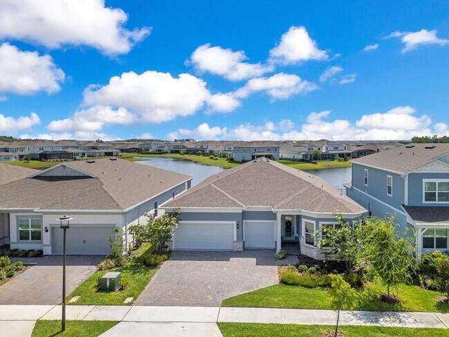 Building Photo - Waterfront Luxury in Isles of Lake Nona | 3-Car Garage, Resort Amenities & HOA-Included Cable, In...