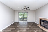 Located at 7545 Tara Rd in Jonesboro, GA, this single-floor residence offers a well-organized layout with a variety of thoughtfully finished spaces. The living area is anchored by a tile-surround fireplace and flows seamlessly into the dining area, where wood-look plank flooring runs throughout. A ceiling fan and sliding glass door lead to a private balcony, filling the space with natural light and outdoor views. The kitchen is efficiently designed with white shaker-style cabinetry, granite countertops, a subway tile backsplash, stainless steel appliances, and a double-basin sink — all complemented by matching wood-look flooring. Multiple bedrooms feature plush wall-to-wall carpeting, neutral toned walls, and windows that allow ample natural light. Each room provides a comfortable and versatile environment suitable for a variety of uses. The unit includes two full bathrooms: one showcasing white cabinetry with granite countertops, a large mirror, and a tub-shower combination, and a second more compact bathroom also featuring a tub-shower with white tile surround. Wood-look flooring in both bathrooms ties the interior together cohesively. The overall aesthetic is clean, modern, and move-in ready.