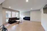 Located at 126 College Ave in Ithaca, NY, this spacious 7-bedroom, 3-bathroom unit offers a practical and functional layout designed to accommodate a large number of occupants comfortably. The single-floor layout connects a generously sized open living area to the kitchen, creating a cohesive communal space. The living room features light wood-style flooring, recessed lighting, and multiple windows that invite natural light, with seating for a large group and a central coffee table. Adjacent to the living area, the kitchen is well-equipped with stainless steel appliances — including a refrigerator, dishwasher, and range — along with ample cabinetry, a double sink, and light countertops. A dining table with seating connects the kitchen to the living space seamlessly. Each of the seven bedrooms is individually sized, with carpeted flooring, neutral-toned walls, and windows providing natural light and outdoor views of the surrounding neighborhood. The primary bedroom offers a comfortable footprint suitable for a full-sized bed and workspace. The three bathrooms are clean and modern, each featuring a vanity with storage, a mirror, and a shower/tub combination with wood-look flooring. Two hallways connect all spaces efficiently throughout the unit.