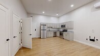 Located at 501 State St in Schenectady, NY, this thoughtfully designed one-bedroom, one-bathroom unit offers a clean, modern aesthetic throughout. The open-concept living and kitchen area is bright and airy, featuring recessed lighting, crisp white walls, and warm light wood-tone flooring that flows seamlessly across the entire space.

The kitchen is well-appointed with gray shaker-style cabinetry, granite-look countertops, and a full suite of stainless steel appliances, including a refrigerator, electric range, built-in microwave, and dishwasher. A wall-mounted mini-split HVAC unit provides efficient climate control in both the main living area and the bedroom.

The bedroom is a comfortable, well-proportioned room featuring two windows that allow natural light to fill the space, a wall-mounted mini-split unit, and direct access to both a walk-in closet and the bathroom. The walk-in closet is equipped with wire shelving and hanging rods for organized storage.

The bathroom features large-format gray tile flooring, a full soaking tub with shower, and a clean, minimalist design. Throughout the unit, white panel doors with black hardware add a contemporary touch. The overall ambiance is fresh, modern, and move-in ready.