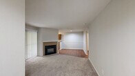 Located at 7303 Bryn Athyn Way in Raleigh, NC, this one-bedroom, one-bathroom residence offers a well-organized single-level layout with a comfortable mix of carpet and wood-look flooring throughout. The combined kitchen and living area forms the heart of the home, anchored by a tile-surround fireplace and sliding glass doors that invite natural light and provide outdoor access. The living space features plush carpeting and a neutral color palette, creating a calm, welcoming atmosphere. The kitchen is well-appointed with warm oak cabinetry offering generous storage, dark granite-style countertops, and a full suite of stainless steel appliances including a refrigerator, dishwasher, and electric range with overhead ventilation. A window above the sink provides natural light and a view of the surrounding greenery. The bedroom is a comfortable retreat with soft carpeting, a ceiling fan with integrated light fixture, and a window that allows natural light to filter in. The full bathroom includes a combined tub and shower unit, a wood-vanity with countertop sink, and wood-look flooring for easy maintenance. Additional spaces include an entrance, hallway, and closet, rounding out the functional layout of this Raleigh residence.