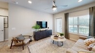 Located in Port Wentworth, Georgia, this thoughtfully designed 2-bedroom, 3-bathroom residence offers a cohesive blend of modern style and everyday functionality across a single floor. Light wood-tone flooring flows throughout, complementing the neutral color palette that unifies the space.

The open-concept kitchen is a standout feature, showcasing gray shaker cabinetry, white quartz countertops, a subway tile backsplash, and a full suite of stainless steel appliances. A large central island with seating and pendant lighting serves as a natural gathering point, connecting the kitchen to the dining and living areas. The living room is bright and welcoming, with large windows offering outdoor views and a ceiling fan overhead.

The spacious primary bedroom features a distinctive blue accent wall, ceiling fan, and direct access to a well-appointed en-suite bathroom complete with a dual-sink vanity, walk-in glass shower, and wood-look tile flooring. A dedicated walk-in closet with built-in shelving provides ample storage. The second bedroom is equally comfortable, served by a full bathroom with a tub-shower combination and clean white tile surround. A third bathroom adds additional convenience. The home also includes a dedicated closet for extra storage needs.