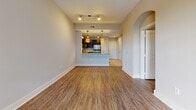 Located at 1925 Monroe Dr NE in Atlanta's vibrant Midtown/Virginia-Highland area, this one-bedroom, one-bathroom unit offers a well-designed layout with comfortable living spaces. The open-concept living and kitchen area forms the heart of the home, featuring warm hardwood-style flooring, neutral wall tones, and track lighting that creates a bright, welcoming atmosphere. A private entry door with sidelights and transom windows draws in abundant natural light from the outdoors. The kitchen is appointed with rich dark-espresso cabinetry, granite countertops, a subway tile backsplash, stainless steel appliances including a refrigerator, microwave, and dishwasher, and pendant lighting above a peninsula that provides additional workspace and casual seating. An elegant arched doorway connects the main living area to the private hallway. The spacious bedroom features large windows with lush green outdoor views, hardwood-style flooring, and a ceiling fan. A dedicated closet provides organized storage. The bathroom is finished with large-format tile flooring, a tiled tub/shower surround, a dark-cabinetry vanity with granite countertop, and clean, modern fixtures. The unit's cohesive design and quality finishes make it a polished and functional living space.