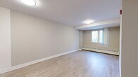 Located at 552 Birchmount Road in Toronto's Scarborough neighbourhood, this one-bedroom, one-bathroom unit offers a practical and efficiently laid-out single-floor living space. Throughout the unit, light wood-look laminate flooring creates a clean, cohesive look that brightens each room.

The living area provides a comfortable open feel, finished with neutral warm-grey walls, white baseboards, and a window that allows natural light to filter in. A baseboard heating unit runs beneath the window, ensuring year-round comfort. The kitchen is positioned adjacent to the living space and includes warm-toned wood cabinetry and a white electric range, offering a functional area for cooking and meal preparation.

The bedroom is a well-proportioned private retreat, featuring the same light flooring and neutral tones. A sliding double-door closet provides ample storage, and a window equipped with a roller blind adds natural light while maintaining privacy.

The bathroom is thoughtfully appointed with light wood-look flooring, a full-sized soaker tub with an overhead shower and curtain rod, a white toilet, and a wood-toned vanity with a white countertop and integrated sink, lending a clean and modern aesthetic.

Overall, the unit presents a tidy, move-in ready living space with a consistent neutral palette and practical finishes throughout.