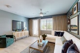 Located at 8165 W Whitney Dr in Peoria, AZ, this single-story, one-bedroom, one-bathroom residence offers a thoughtfully designed layout across a comfortable footprint. Light wood-style flooring flows throughout, tying together a cohesive, modern aesthetic.

The living room is bright and inviting, featuring a ceiling fan, large windows with elegant draping, and a sliding glass door that leads to a private patio, allowing natural light to fill the space. The kitchen is well-equipped with light wood cabinetry, stainless steel appliances including a full-size refrigerator, electric range, and built-in microwave, complemented by a white quartz countertop, a tiled backsplash, and a peninsula with bar seating ideal for dining.

The bedroom offers a generous footprint with dual windows, blackout draping, and light wood flooring, creating a calm retreat. It is complemented by a dedicated walk-in closet featuring dual hanging rods and shelving for ample storage. The bathroom makes a bold design statement with bold patterned wallcovering, a soaking tub and shower combo with sliding glass doors, a wood-toned vanity, and white countertops.

A dedicated laundry room houses a full-size stacked washer and dryer, adding everyday convenience to this well-rounded Peoria residence.