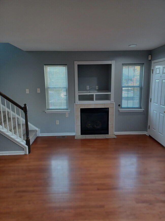 Living room with gleaming h/w floors, cozy gas fireplace, media built-ins - 116 E Moreland Ave