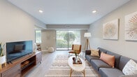 Located at 1501 E Central Rd in Arlington Heights, IL, this single-floor residence offers a thoughtfully designed 1-bedroom, 2-bathroom layout that maximizes both comfort and functionality. The open-concept living room features light hardwood-style flooring, recessed lighting, and a large sliding glass door that floods the space with natural light while providing a view of lush greenery outside. The living area flows seamlessly into the dining space, which includes a dedicated nook with a window, and into the kitchen. The kitchen is well-equipped with rich dark-wood cabinetry, quartz countertops, a gray subway tile backsplash, stainless steel appliances including a refrigerator, range, microwave, and dishwasher, and a deep single-basin sink. The spacious primary bedroom features plush carpeting, a bold accent wall in deep teal, natural window light, and generous closet space with bifold doors. Both bathrooms are finished with warm earth-toned tile, including a full bath with a tub-shower combination and dark wood vanity cabinetry. A hallway connects the private areas of the home, completing a functional and cohesive floor plan throughout.