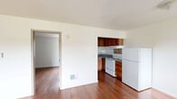 Located at 406 W Morrison Ave in Santa Maria, California, this one-bedroom, one-bathroom unit offers a practical and well-organized single-floor layout. Warm hardwood-style flooring runs throughout the entire space, creating a cohesive and inviting atmosphere from room to room.

The open living area is bright and airy, receiving natural light through a front-facing window positioned beside the entry door. The space flows seamlessly into the kitchen, which features rich warm-toned wood cabinetry — both upper and lower — paired with granite-look countertops and a double stainless steel sink. White appliances, including a range and refrigerator, complete the functional kitchen setup.

The bedroom offers a clean, quiet retreat with neutral white walls and the same consistent hardwood-style flooring. Two closets provide ample storage throughout the unit. The bathroom includes a full tub and shower combination with white surround panels, a toilet, and a vanity with matching wood cabinetry and granite-look countertop. Clean lines and neutral finishes throughout give the space a simple, move-in-ready character well-suited for comfortable everyday living in the heart of Santa Maria.