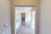 Located at 6244 Rivoli Dr in Chattanooga, TN, this single-story 2-bedroom, 1-bathroom home offers a thoughtfully designed layout with modern finishes throughout. The entrance opens into a flowing living area featuring light hardwood-style flooring, neutral warm-toned walls, and a ceiling fan. A tray ceiling with crown molding adds architectural character to the main living space, which is filled with natural light from large windows and glass doors that provide outdoor views.

The kitchen is a standout feature, boasting granite countertops, white shaker-style cabinetry, a classic subway tile backsplash, and stainless steel appliances including a refrigerator, range, and microwave. A kitchen island provides additional prep and dining space, seamlessly connecting to the dining area. One bedroom features a stylish sliding barn door, while the primary bedroom offers a walk-in closet equipped with wire shelving and hanging rods. The bathroom includes a granite-topped vanity, hardwood-style flooring, and a full tub-shower combo. A dedicated laundry room houses a full-size washer and dryer. This home combines practical functionality with clean, contemporary design.