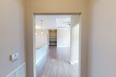 Located at 6244 Rivoli Dr in Chattanooga, TN, this single-story 2-bedroom, 1-bathroom home offers a thoughtfully designed layout with modern finishes throughout. The entrance opens into a flowing living area featuring light hardwood-style flooring, neutral warm-toned walls, and a ceiling fan. A tray ceiling with crown molding adds architectural character to the main living space, which is filled with natural light from large windows and glass doors that provide outdoor views.

The kitchen is a standout feature, boasting granite countertops, white shaker-style cabinetry, a classic subway tile backsplash, and stainless steel appliances including a refrigerator, range, and microwave. A kitchen island provides additional prep and dining space, seamlessly connecting to the dining area. One bedroom features a stylish sliding barn door, while the primary bedroom offers a walk-in closet equipped with wire shelving and hanging rods. The bathroom includes a granite-topped vanity, hardwood-style flooring, and a full tub-shower combo. A dedicated laundry room houses a full-size washer and dryer. This home combines practical functionality with clean, contemporary design.