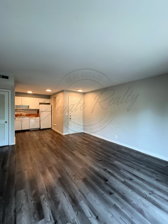 Building Photo - One Bedroom Condo, FIRST FLOOR, Assigned P...