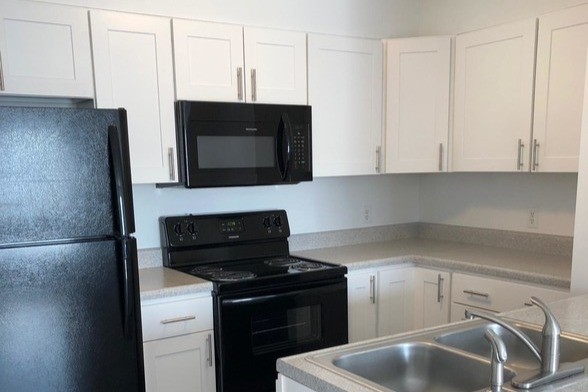 Premium Unit kitchen. Additional fees may apply - Regency Apartments