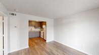 Located at 2413 W Prairie St in Denton, Texas, this one-bedroom, one-bathroom unit offers a practical and well-organized single-floor layout. Wood-look plank flooring runs consistently throughout the space, contributing to a cohesive and clean aesthetic across every room.

The living room is a bright, open area featuring a front-facing window that allows natural light to filter in alongside the entry door. The space flows directly into the kitchen, which is accessible through an arched pass-through opening. The kitchen is well-equipped with ample gray shaker-style cabinetry, light granite-look countertops, a white electric range, a refrigerator, and a single-basin sink. A pendant light and flush-mount ceiling fixture provide functional illumination, while the textured ceiling is a consistent feature throughout the unit.

The bedroom is a comfortable, well-proportioned room with a window overlooking the outdoors, providing natural light and ventilation. It connects directly to a dedicated walk-in closet outfitted with dual hanging rods on opposing walls, offering generous storage capacity. The full bathroom is conveniently accessible from the bedroom and features a full-size bathtub with shower, a vanity, and a toilet. The clean white finishes in the bathroom maintain the unit's neutral, functional design throughout.