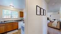 Located at 95 Campus Dr in Buffalo, NY, this single-floor, 2-bedroom, 1-bathroom residence offers a practical and efficiently arranged layout. The kitchen features warm oak cabinetry, dark granite-style countertops, a double-basin stainless steel sink positioned beneath a window that allows natural light to fill the space, and includes a range and dishwasher. Two connecting hallways guide movement throughout the unit, contributing to a logical and accessible flow between rooms. The primary bedroom is a comfortably sized retreat with carpet flooring, a natural light-filled window with curtains, and a dedicated closet. The second bedroom mirrors similar features, including carpeted floors, a window with blinds, and a closet, making it equally suitable as a sleeping space or home office. The full bathroom is finished with classic white tilework, a tub-shower combination, a pedestal sink, and a window providing ventilation. Neutral wall tones and carpet flooring in the bedrooms create a calm, cohesive ambiance throughout the residence. The overall design prioritizes functionality and comfort, making it a practical choice for everyday living in the Buffalo area.