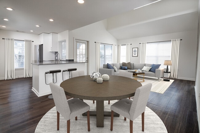 Kitchen, living, and dining areas with hard-surface flooring - Avalon at Bedford Center