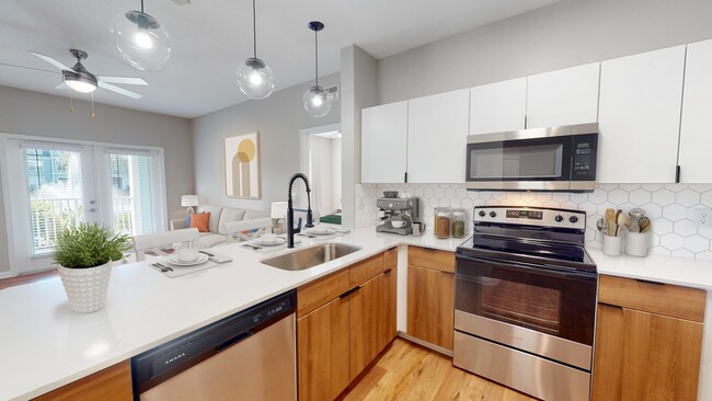 Newly Renovated Kitchen with Stainless Steel Appliances - The Enclave at Tranquility Lake Apartments