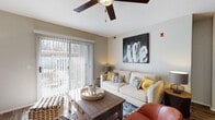 Located in Cottonwood Heights, Utah, this well-appointed single-floor residence offers a thoughtfully designed layout with comfortable living spaces throughout. The living room is bright and welcoming, featuring a ceiling fan, wood-style flooring, and a large sliding glass door with vertical blinds that floods the room with natural light and provides outdoor access. The adjacent dining area offers a defined space for meals, accented by angled ceilings that add architectural character. The kitchen is efficiently laid out with white cabinetry, dark countertops, a stainless steel sink, and a dishwasher, complemented by wood-style flooring and ample storage. Two bedrooms provide restful retreats, each featuring ceiling fans, plush carpeting, and large windows that invite natural light. The primary bedroom connects to a spacious en-suite bathroom with a wide vanity, white cabinetry, dark countertops, wood-style flooring, and a walk-in closet. A second full bathroom offers similar finishes, including a tub-shower combination. A dedicated in-unit laundry room with washer hookups and a water heater adds everyday convenience. Throughout the home, neutral tones and consistent finishes create a cohesive, modern ambiance.