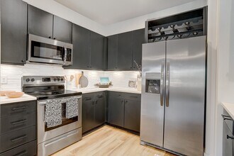 Kitchen with Quartz Countertop and Stainless Steel Appliances. - The Parian Mooresville