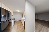 This one-bedroom, one-bathroom unit in North Syracuse, NY offers a practical and well-organized single-floor layout. The kitchen is equipped with white cabinetry, a stainless steel sink, electric range, and a refrigerator, with a half-wall partition that separates it from the adjacent living area while maintaining an open feel. The living spaces feature light wood-style flooring and baseboard heating, creating a clean and functional environment. A window in the kitchen area allows for natural light to filter in. The bedroom is a comfortable size, finished with plush carpeting, a window overlooking the outdoors, and a mirrored sliding-door closet that adds both storage and a sense of depth to the room. In addition to the bedroom closet, the unit includes multiple closets throughout, providing generous storage options. The bathroom features a full tub-shower combo with a white surround unit and chrome fixtures. A connecting hallway links the living and private areas of the unit seamlessly. With its neutral color palette, practical layout, and key amenities, this unit offers a straightforward and functional living space in North Syracuse.