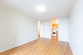 Located at 15 Regency Cres in Whitby, Ontario, this efficient one-bedroom, one-bathroom unit offers a thoughtfully organized layout across a single floor. Warm hardwood-style flooring flows consistently throughout the space, lending a cohesive and welcoming feel to every room.

The living room is a bright, open area highlighted by large floor-to-ceiling windows that wrap around a corner, flooding the space with natural light and offering pleasant views of the surrounding neighbourhood's treetops and streetscape. A pendant light fixture adds a touch of character, while a sliding glass door provides access to a balcony. Baseboard heating runs along the perimeter beneath the windows.

The bedroom is a well-proportioned private retreat with neutral walls, clean white trim, and ample wall outlets, offering a versatile blank canvas for furnishing.

The bathroom is neatly finished with white cabinetry offering generous storage, a taupe laminate countertop, a wide vanity mirror with overhead lighting, and a combined shower-tub enclosure. Hardwood-style flooring continues into this space for a seamless look.

A central hallway connects all rooms efficiently, featuring a textured ceiling and clean white walls. The unit's neutral colour palette and consistent finishes create a calm, functional living environment suitable for a variety of lifestyles.