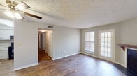 Located at 1630 London Town Lane in Montgomery, Alabama, this single-story residence offers a well-organized layout with a practical blend of finishes throughout. The living area is a standout space, featuring rich wood-style flooring, a textured ceiling, and a ceiling fan overhead. A fireplace with a wood mantel and tiled surround serves as a focal point, while a window and glass-paned door allow natural light to fill the room and provide outdoor access.

The kitchen is equipped with white shaker-style cabinetry extending to the ceiling, light stone-look countertops, a stainless steel double-basin sink, and black appliances including an electric range and dishwasher. Light wood-style flooring continues through this space.

The bedrooms are carpeted and feature neutral wall tones, textured ceilings, and windows that bring in natural light, creating comfortable, quiet retreats. A hallway connects the living areas to the private rooms.

Two bathrooms serve the home, each featuring a tiled tub-shower combination, toilet, and vanity with a single basin sink, stone-look countertop, and white cabinetry. A well-lit mirror and wall-mounted lighting complete each bathroom's functional design.