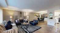 Located at 16861 Saddlewood Trail in Minnetonka, MN, this two-story home offers a well-designed layout spread across two floors. The main level features an open-concept living, dining, and kitchen area anchored by warm hardwood-style flooring. The living room is bright and inviting, highlighted by a tray ceiling, large windows with vertical blinds that invite natural light, and views of the surrounding greenery. The dining area accommodates a full dining set and is accented by a pendant chandelier and bold wall art. The kitchen is equipped with white shaker cabinetry, light countertops, stainless steel appliances, and a breakfast bar with seating — ideal for casual dining. In-unit laundry is also conveniently located off the kitchen. The upper level hosts two carpeted bedrooms, including a spacious primary bedroom with a mirrored closet, natural window light, and an en-suite bathroom featuring a sliding glass shower enclosure and vanity with ample storage. A versatile office with large sliding-panel closets and a window rounds out the upper level. Three full bathrooms are distributed throughout, each finished with clean white cabinetry and mosaic tile flooring. Six closets provide generous storage throughout the home.