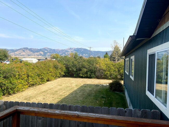 Front porch view of the Bridger Mountain Range and front fenced yard - 4270 E Valley Center Rd