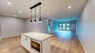 This well-appointed 2-bedroom, 2-bathroom residence at 1850 Green Bay Rd in Highland Park, IL offers a thoughtfully designed single-level layout with generous living space. The open-concept kitchen and living area serves as the heart of the home, featuring light hardwood-style flooring, crisp white shaker cabinetry, stainless steel appliances including a gas range and French door refrigerator, a chevron tile backsplash, and a central island with pendant lighting overhead. The living area flows seamlessly from the kitchen, with large windows bringing in natural light and views of the surrounding neighborhood. Both bedrooms are carpeted and well-sized, with the primary bedroom offering direct access to an en-suite bathroom and a walk-in closet outfitted with custom shelving and dual hanging rods. The primary bath features a glass-enclosed walk-in shower with floor-to-ceiling tile, a rainfall showerhead, and a built-in niche. The second bathroom is finished with large-format tile flooring, a white vanity with under-mount sink, and a lighted mirror. Additional highlights include a dedicated in-unit laundry closet with a stacked washer and dryer, two closets for ample storage, and a neutral color palette throughout that lends a clean, modern ambiance to the entire residence.