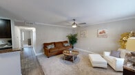 Located at 4101 E Nasa Pkwy in El Lago, TX, this well-appointed 2-bedroom, 2-bathroom single-story home offers a thoughtfully designed layout across a comfortable footprint. The open living and dining area features hardwood-style flooring, crown molding, and a ceiling fan, creating a bright and inviting atmosphere. The dining space accommodates a full table and benefits from natural light through large windows with blinds.

The galley-style kitchen is a standout feature, showcasing rich dark cabinetry, granite countertops, stainless steel appliances, and generous storage across both sides of the corridor layout. The kitchen flows seamlessly into the dining and living areas.

Both bedrooms are carpeted and offer comfortable proportions. The primary bedroom includes a ceiling fan with light fixture, a large window for natural light, and access to a walk-in closet with wire shelving. The second bedroom also connects conveniently to the hallway.

The two bathrooms are finished with tile surrounds and granite vanity countertops. One bathroom features a tub/shower combination, while the other includes a dedicated walk-in shower with decorative tile banding. A connecting hallway ties all rooms together efficiently, completing this functional and well-finished home.