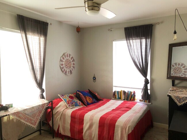 Bedroom two has a white ceiling with light grey walls and tiled floors. New modern ceiling fans. - 2005 Bouldin Avenue