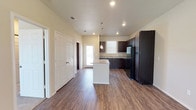 This single-story home in Lubbock, TX offers a well-designed, open-concept layout that seamlessly connects the living and kitchen areas. The main living space features durable wood-look flooring, neutral-toned walls, and a ceiling fan with integrated lighting, contributing to a bright and comfortable atmosphere. Natural light filters in through blinded windows, enhancing the welcoming feel of the space.

The kitchen is a functional highlight, outfitted with rich dark-stained cabinetry that extends to the ceiling for ample storage, light granite countertops, a double-basin stainless steel sink, and a full suite of black appliances including a range, microwave, refrigerator, and dishwasher. A peninsula with pendant lighting provides additional prep space and connects the kitchen to the living area.

The bedrooms are finished with plush carpeting and ceiling fans, each receiving natural light through windows with blinds. The bathrooms are consistent in style, featuring dark cabinetry vanities with granite countertops. One bathroom includes a tub and shower combination, while another offers a single-vanity layout with wood-look flooring. The overall design maintains a cohesive, modern aesthetic throughout.