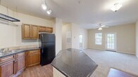 Located at 140 N Davis Rd in LaGrange, Georgia, this single-story, 3-bedroom, 2-bathroom home offers a functional and well-appointed layout. The combined kitchen and dining area serves as the heart of the home, showcasing warm wood cabinetry, dark granite countertops, a peninsula island, track lighting, and black appliances including a range and refrigerator. Hardwood-style flooring in the kitchen transitions smoothly into the carpeted living room, which features a ceiling fan and a glass-paneled door that fills the space with natural light. A hallway connects the living areas to the three bedrooms, each carpeted and featuring windows with blinds that allow for natural light. The spacious primary bedroom includes a ceiling fan and connects conveniently to one of the two bathrooms, which features hardwood-style flooring, a rich wood vanity with dark granite countertop, a large mirror, and stylish overhead lighting. Additional highlights include three closets for ample storage and a dedicated laundry area. The neutral, warm beige tones throughout the home create a cohesive and inviting ambiance, making this residence a comfortable and practical living space.
