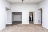 This single-floor residence in Macon, Georgia, offers a practical and comfortable layout designed for everyday living. The interior is finished with a neutral gray color palette throughout, creating a cohesive and clean aesthetic from room to room.

The kitchen is well-appointed with ample white cabinetry providing generous storage, light-toned countertops, and a full suite of black appliances including an electric range, refrigerator, and dishwasher. Light wood-look flooring runs through the kitchen, adding warmth to the functional space.

The living areas are carpeted in a neutral brown tone, lending a comfortable feel underfoot. A spacious room features sliding glass doors dressed with vertical blinds, allowing abundant natural light to pour in while offering access to the outdoors. Ceiling fans with light fixtures are present in multiple rooms, enhancing air circulation and illumination.

One bedroom showcases notably elevated ceilings, creating an open, airy atmosphere, and includes a recessed nook area that offers additional flexible space. Other bedrooms are well-sized with windows that invite natural light and ceiling fan fixtures overhead.

The bathroom is neatly finished with wood-look flooring, a gray-toned vanity with stone-look countertop, a large mirror, chrome hardware, and a full tub-shower combination. Clean white walls and bright lighting complete the polished look of this well-maintained Macon home.