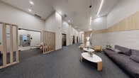 This contemporary office space, located at 300 Place Charles-le Moyne in Longueuil, Quebec, spans 2,460 square feet on a single floor. The interior design seamlessly blends functionality with modern aesthetics, creating an inviting and productive work environment. The space features an open-concept layout with various work areas and lounge spaces.

Upon entering, visitors are greeted by a sleek reception area with comfortable seating and marble-topped coffee tables. The main workspace showcases a mix of individual workstations and collaborative areas, adorned with stylish hanging egg chairs and modern furniture. High ceilings and strategically placed lighting fixtures, including a striking circular LED light, enhance the sense of spaciousness.

The office boasts a sophisticated color palette of neutral tones, with white walls, light wood accents, and gray carpeting throughout. Textural elements, such as textured wall panels and patterned flooring, add visual interest. Large windows allow natural light to flood the space, while glass partitions maintain an open feel while providing privacy where needed.

A dedicated lounge area features plush seating and a motivational wall quote, promoting a balance between work and relaxation. The space also includes a well-appointed kitchenette and multiple meeting rooms to accommodate various business needs. State-of-the-art amenities, including elevators and advanced lighting systems, ensure a comfortable and efficient work environment.