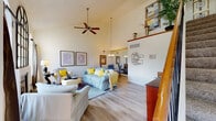 Located in Chesterfield, Missouri, this thoughtfully designed 3-floor home offers a versatile layout with distinct spaces across each level. The main floor welcomes you through a light-filled foyer with an elegant staircase featuring warm wood railings and black balusters. The expansive living room commands attention with soaring vaulted ceilings, a ceiling fan, and light wood flooring throughout, creating an airy and open atmosphere. The space flows naturally into a dedicated dining area with ample room for entertaining. The kitchen is outfitted with crisp white cabinetry, granite countertops, stainless steel appliances, and a deep sink — combining style with functionality. A well-appointed bathroom with striped accent walls and a wide vanity adds convenience to the main level. Upstairs, a private home office provides a quiet retreat, featuring hardwood-style flooring, a window with natural light, and thoughtful built-in storage. The lower level is highlighted by a cinema-inspired media room, complete with plush carpeting, a large sectional, and decorative film reel accents on the walls — ideal for movie nights and entertainment. Each level of this home offers a distinct character, making it a well-rounded and functional residence in the heart of Chesterfield.