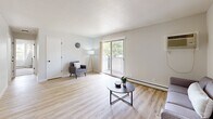 Located at 7800 Iltis Dr in Urbandale, Iowa, this single-floor unit offers a clean, modern aesthetic throughout its well-organized layout. The kitchen is outfitted with white shaker-style cabinetry, dark countertops, a stainless steel sink with a matte black faucet, and full appliances including a refrigerator, range, microwave, and dishwasher — all set over light wood-look flooring. Adjacent to the kitchen, the dining area features a ceiling fan and a sliding closet, creating a comfortable and functional space for everyday meals. The living room is bright and open, highlighted by a sliding glass door that leads to a private balcony with outdoor views, light hardwood-style flooring, and a textured ceiling. A second, more intimate sitting area provides additional living space with its own ceiling fan. The two bedrooms are carpeted and comfortably sized, each featuring large windows that bring in natural light, baseboard heating, and closet storage. The bathroom includes a full soaking tub and shower combo with clean white surround panels and chrome fixtures. Throughout the unit, a neutral color palette and consistent finishes create a cohesive, move-in-ready environment.