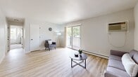Located at 7800 Iltis Dr in Urbandale, Iowa, this single-floor unit offers a clean, modern aesthetic throughout its well-organized layout. The kitchen is outfitted with white shaker-style cabinetry, dark countertops, a stainless steel sink with a matte black faucet, and full appliances including a refrigerator, range, microwave, and dishwasher — all set over light wood-look flooring. Adjacent to the kitchen, the dining area features a ceiling fan and a sliding closet, creating a comfortable and functional space for everyday meals. The living room is bright and open, highlighted by a sliding glass door that leads to a private balcony with outdoor views, light hardwood-style flooring, and a textured ceiling. A second, more intimate sitting area provides additional living space with its own ceiling fan. The two bedrooms are carpeted and comfortably sized, each featuring large windows that bring in natural light, baseboard heating, and closet storage. The bathroom includes a full soaking tub and shower combo with clean white surround panels and chrome fixtures. Throughout the unit, a neutral color palette and consistent finishes create a cohesive, move-in-ready environment.