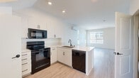 Located at 2915 E St in San Diego's 92102 neighborhood, this modern multi-story home offers three bedrooms, two bathrooms, and a well-organized layout spread across four floors. Light-toned luxury vinyl plank flooring flows throughout, complementing the clean, neutral palette that defines the interior aesthetic.

The kitchen is outfitted with crisp white cabinetry, light quartz countertops, and a full suite of black appliances including a refrigerator, electric range, built-in microwave, and dishwasher. A peninsula provides additional prep space, and the open sightlines connect the kitchen seamlessly to the living area, which benefits from abundant natural light through large windows.

The bedrooms are bright and airy, with multiple windows framing neighborhood and treetop views. The spacious primary bedroom offers a comfortable, well-proportioned retreat. Both bathrooms feature a consistent design language — white vanities with stone countertops, tub-shower combinations, and dark matte hardware accents that add a refined contrast to the light surroundings.

A wall-mounted mini-split system provides climate control in the living area. Multiple staircases connect the four levels efficiently, with hallways linking each zone of the home. The overall design is clean, contemporary, and move-in ready.