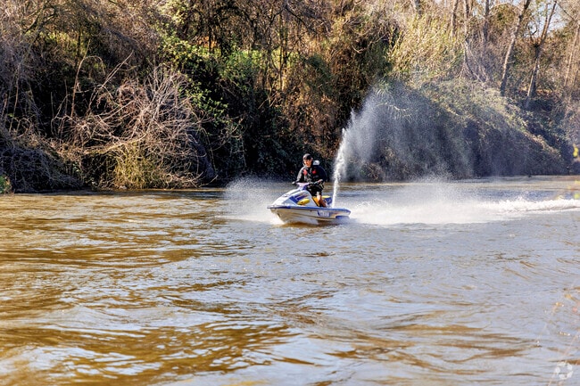 A rider speeds across the Stanislaus River in Riverbank.