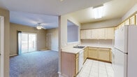 Located at 1260 E Guinevere St in Springfield, MO, this single-floor, one-bedroom, one-bathroom unit offers a practical and comfortable layout. The living room is a generously sized, carpeted space anchored by a ceiling fan with light fixture, neutral beige walls, and a sliding glass door that opens to an outdoor deck, bringing in natural light and providing easy outdoor access. Adjacent to the living area, a dedicated dining space connects seamlessly to the kitchen via a convenient pass-through window. The kitchen features light wood cabinetry, tile flooring, ample counter space, a double sink, dishwasher, refrigerator, and a skylight-style overhead fixture that brightens the room. A hallway connects the main living areas to the private bedroom, which is spacious and carpeted with a ceiling fan, a natural light window, and a closet with built-in rod storage. The bathroom includes tile flooring, a tub-shower combination with sliding glass doors, and clean, neutral finishes. Additional spaces include a utility room, laundry area, and two closets, ensuring practical storage throughout. The consistent neutral palette and carpet flooring unify the space for a cohesive, move-in-ready feel.