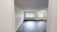 Located at 4906 123rd St SW in Lakewood, Washington, this well-maintained 2-bedroom, 2-bathroom single-story home offers a thoughtfully organized layout across its comfortable footprint. The open living area is highlighted by wood-style plank flooring, textured ceilings, and multiple windows fitted with blinds that fill the space with natural light. Baseboard heaters line the walls, ensuring efficient climate control throughout.

The kitchen is clean and functional, featuring white cabinetry with ample upper and lower storage, light countertops, and black appliances including a range, dishwasher, and refrigerator. Overhead flush-mount lighting and wood-style flooring complete the space. A sliding door provides additional access from the kitchen area.

Both bedrooms are carpeted and offer a calm, neutral palette, with each room featuring a ceiling fan with light fixture, textured ceilings, and sliding-door closets for generous storage. Windows with blinds allow natural light into each room.

The two bathrooms are finished with wood-style flooring, white vanities, and clean fixtures. One bathroom includes a walk-in shower stall, while the other features a full vanity setup. Additional highlights include three closets, a dedicated laundry area, and two hallways that connect the layout efficiently.