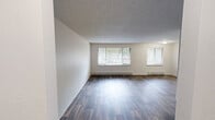 Located at 4906 123rd St SW in Lakewood, Washington, this well-maintained 2-bedroom, 2-bathroom single-story home offers a thoughtfully organized layout across its comfortable footprint. The open living area is highlighted by wood-style plank flooring, textured ceilings, and multiple windows fitted with blinds that fill the space with natural light. Baseboard heaters line the walls, ensuring efficient climate control throughout.

The kitchen is clean and functional, featuring white cabinetry with ample upper and lower storage, light countertops, and black appliances including a range, dishwasher, and refrigerator. Overhead flush-mount lighting and wood-style flooring complete the space. A sliding door provides additional access from the kitchen area.

Both bedrooms are carpeted and offer a calm, neutral palette, with each room featuring a ceiling fan with light fixture, textured ceilings, and sliding-door closets for generous storage. Windows with blinds allow natural light into each room.

The two bathrooms are finished with wood-style flooring, white vanities, and clean fixtures. One bathroom includes a walk-in shower stall, while the other features a full vanity setup. Additional highlights include three closets, a dedicated laundry area, and two hallways that connect the layout efficiently.